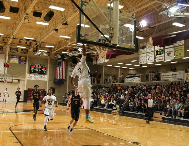 Freshman guard Jalonni McCovery slams down two of his 13 points during the Plainsmen's 103-89 victory over North Platte.