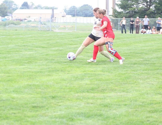 Ashlyn Mustain battles against a Colorado Northwestern opponent for control of the ball.